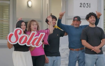 Family in front of their sold home